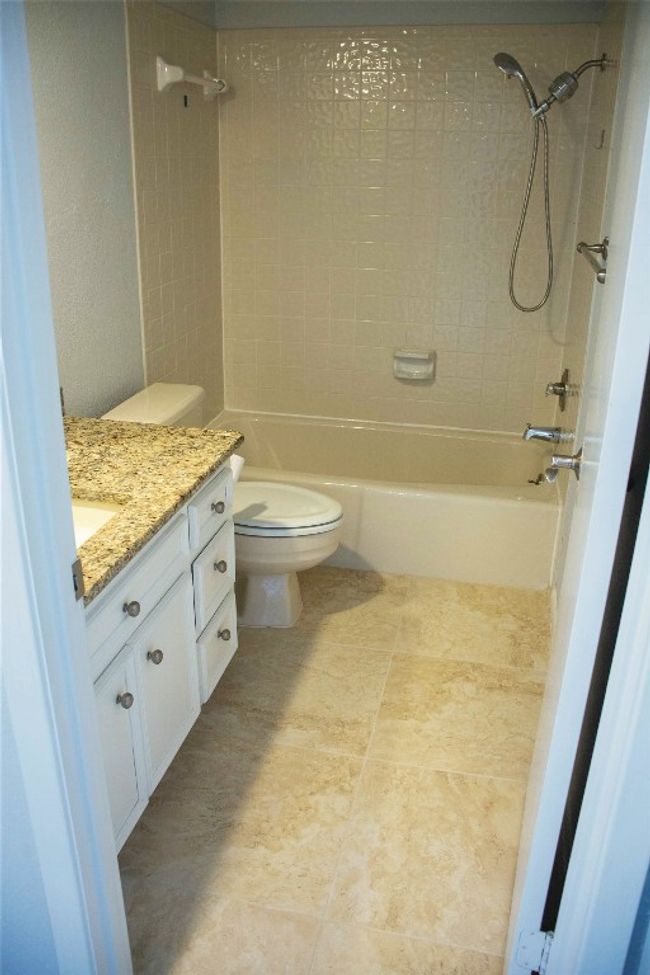 secondary bathroom with vanity, toilet, and bathtub / shower combination with marble flooring | Image 24