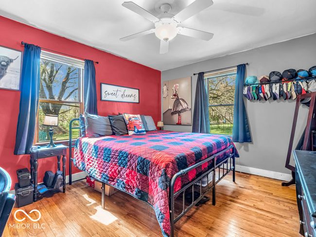 Primary bedroom featuring hardwood flooring, a ceiling fan, 2 closets | Image 12