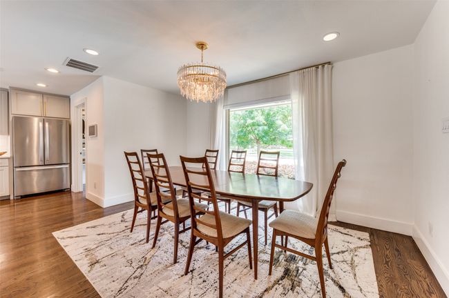 Dining area featuring wood finished floors, baseboards, recessed lighting, and a chandelier | Image 14