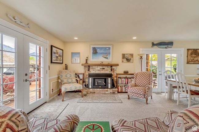 Carpeted living area with a fireplace, wainscoting, recessed lighting, and french doors | Image 21