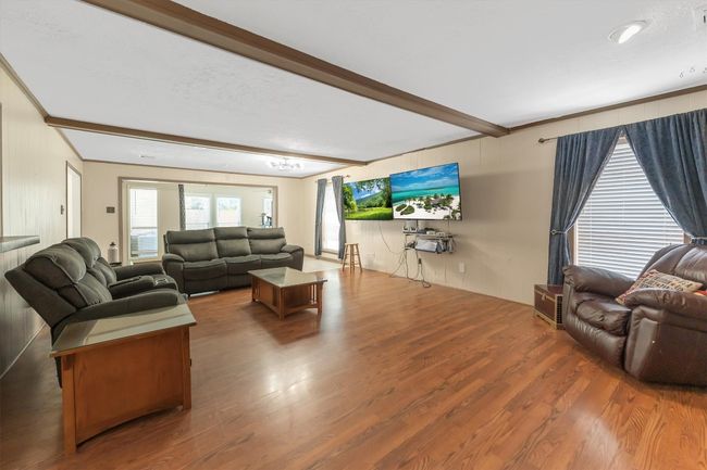 Living area featuring wood finished floors and beamed ceiling | Image 16