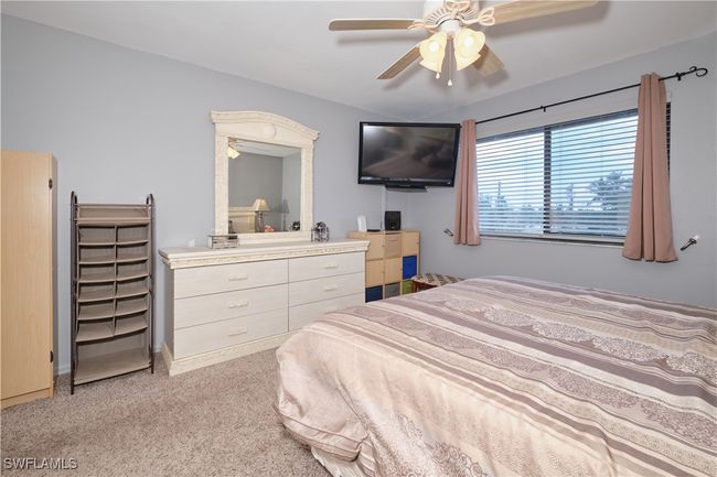 Bedroom featuring light carpet and a ceiling fan | Image 20
