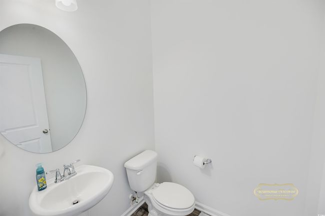 Bathroom with a sink, toilet, and baseboards | Image 18