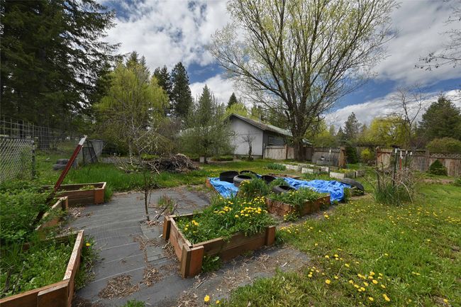 View of yard featuring a garden and fence | Image 60
