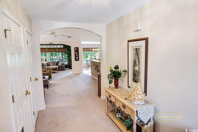 Corridor with arched walkways and light carpet | Image 6