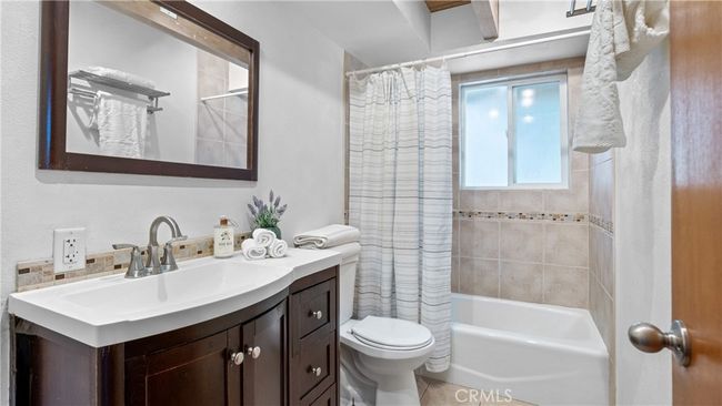Full bathroom on main level with tub and shower with tile surround. | Image 22