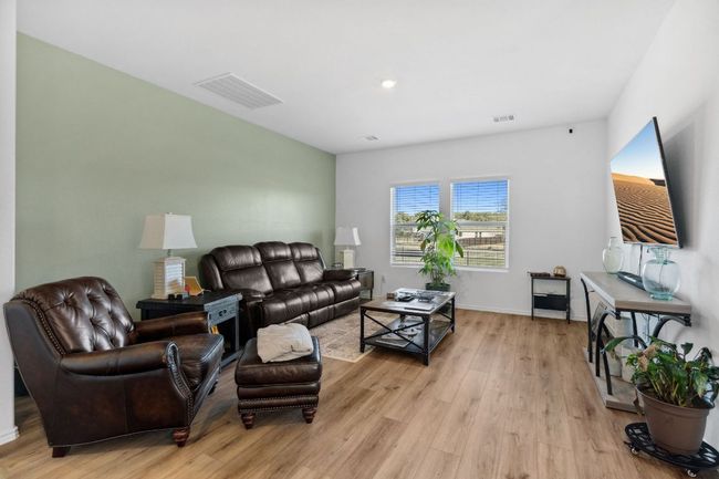 Living room featuring light wood-style flooring, visible vents, and baseboards | Image 6