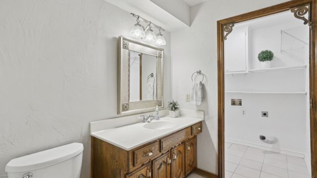 Half bath with baseboards, vanity, toilet, and tile patterned flooring | Image 29