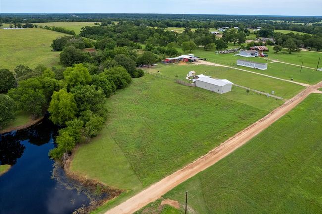 Aerial view of sparsely populated area featuring a nearby body of water | Image 6