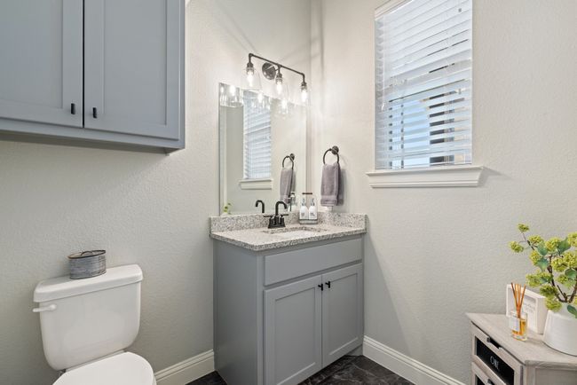 Half bathroom with vanity, toilet, and baseboards | Image 24