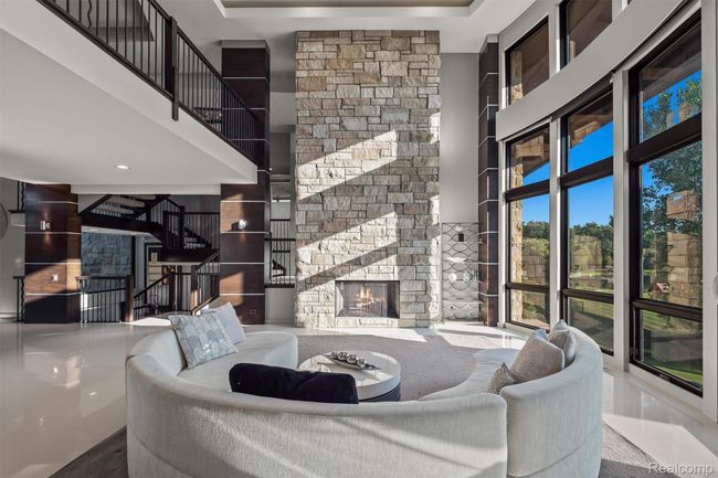Living room with a stone fireplace and a towering ceiling | Image 41