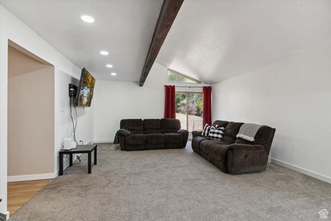 Carpeted living room featuring recessed lighting, wooden beam and baseboards | Image 14