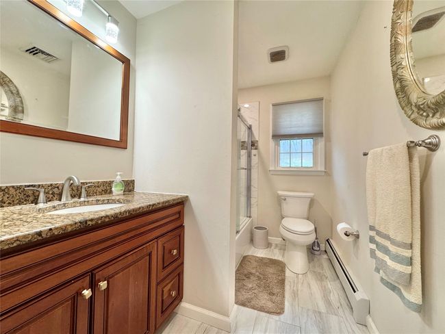Full bath featuring visible vents, baseboards, toilet, baseboard heating, and vanity | Image 16