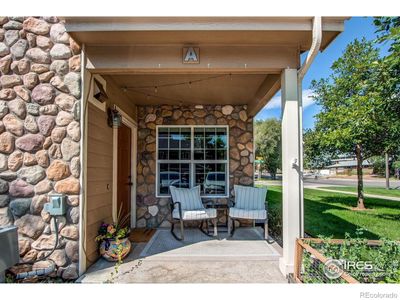 Cozy porch welcomes you into this bright and spacious end-unit townhome | Image 2