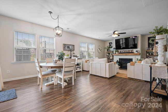 Great room has LVP flooring, new FP mantle, ship-lap feature wall by fireplace | Image 7