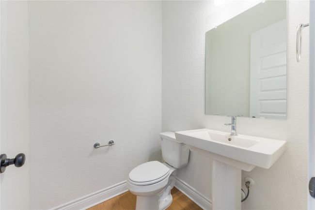 Half bathroom with baseboards and wood finished floors | Image 29
