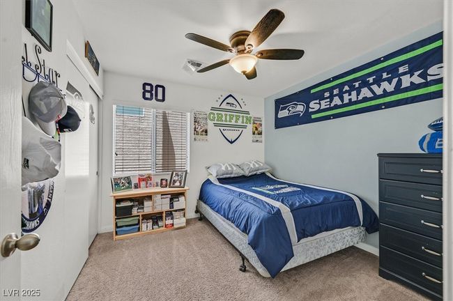 Carpeted bedroom with a ceiling fan | Image 22