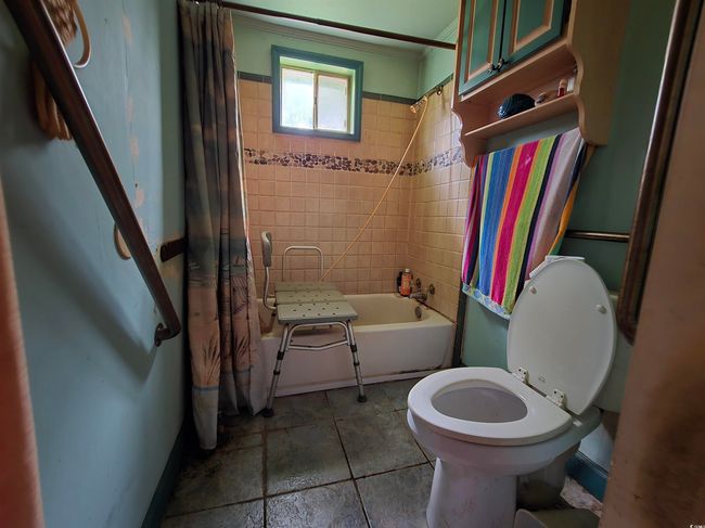 Bathroom featuring shower / bath combo, ornamental molding, toilet, and tile patterned flooring | Image 4