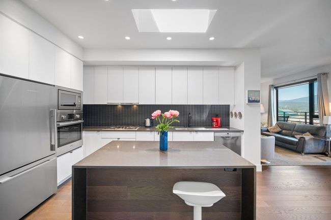 Kitchen with appliances with stainless steel finishes, modern cabinets, white cabinets, and recessed lighting | Image 5