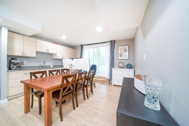 Dining room with light wood-style flooring and recessed lighting | Image 26