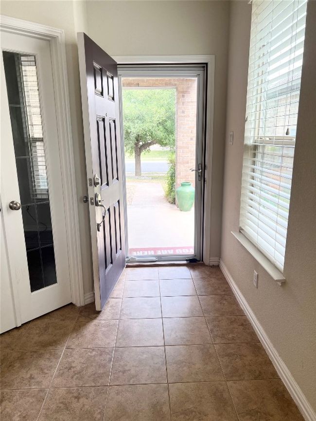 Tiled entrance foyer with baseboards | Image 6