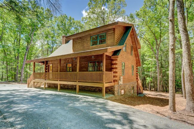 Log home with covered porch, stairway, a chimney, and log siding | Image 43