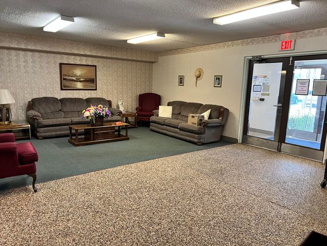 Seating area just inside the entrance to the building. | Image 25