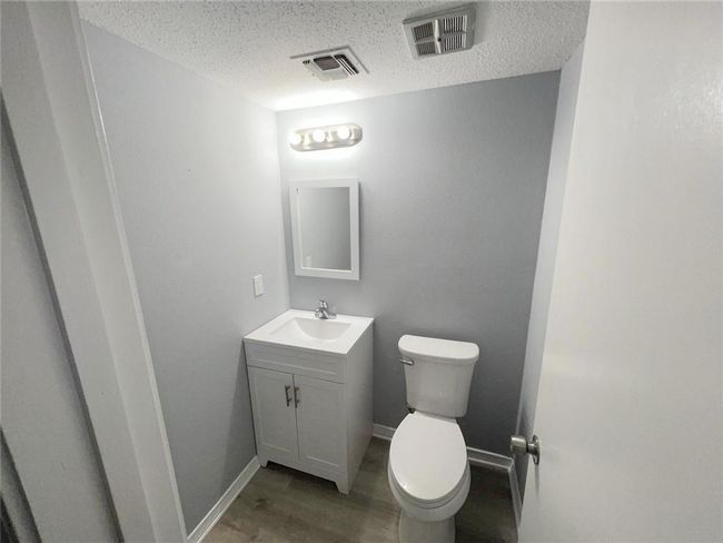 Halb Bath under stairs by Garage Entrance. | Image 16