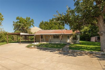 View of front of property featuring a front lawn and a carport | Image 1