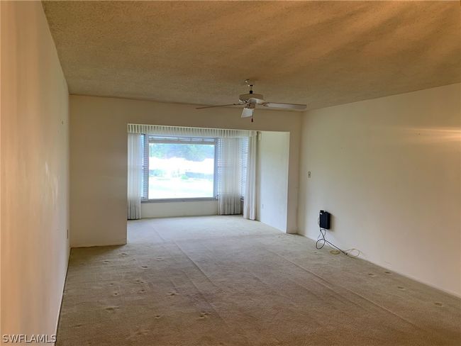Carpeted living room and ceiling fan | Image 5