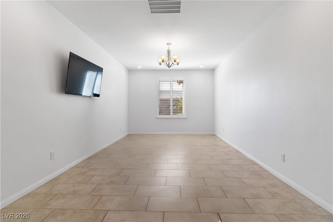 Den featuring a chandelier, recessed lighting, visible vents, and baseboards. Table/personal items removed virtually for picture. | Image 37