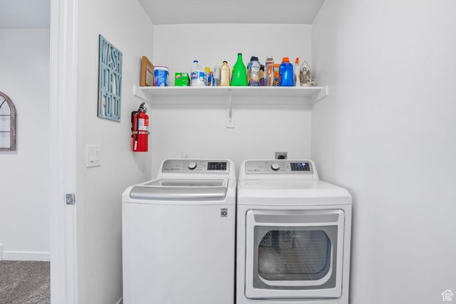 Clothes washing area featuring carpet, baseboards, washer and clothes dryer, and laundry area | Image 21