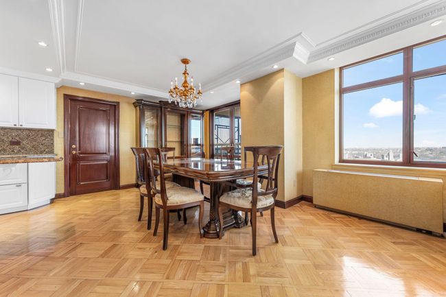 Dining room with a chandelier, ornamental molding, plenty of natural light, a tray ceiling, and recessed lighting | Image 6