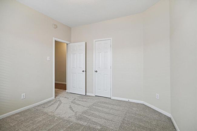 Versatile third bedroom with new carpet and fresh paint (May 2025) can serve as a home craft area, nursery, or guest room, tailored to your needs. | Image 21