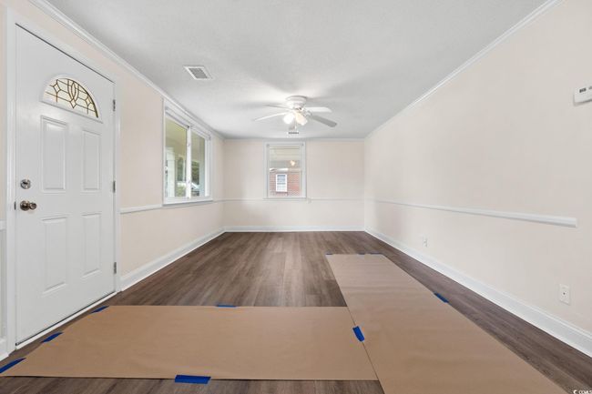 Foyer entrance with a ceiling fan, ornamental molding, dark wood-style floors, and baseboards | Image 19