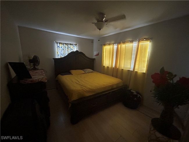 Bedroom featuring wood finished floors and a ceiling fan | Image 6