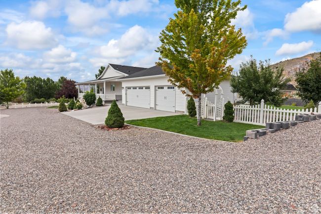 View of front of property with driveway, an attached garage, a porch, and a mountain view | Image 105