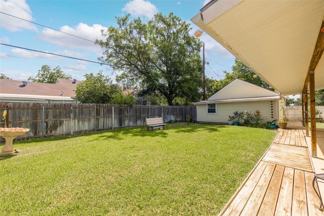 View of fenced backyard and detached 2 car garage. Located inside the garage is an additional workspace. | Image 33