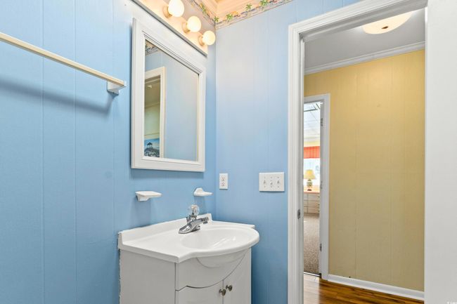 Bathroom featuring hardwood / wood-style floors, vanity, and ornamental molding | Image 19