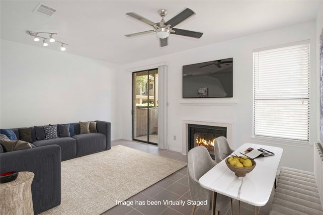 Virtually staged to show one option as to how you could arrange Living and Dining in this room. | Image 4