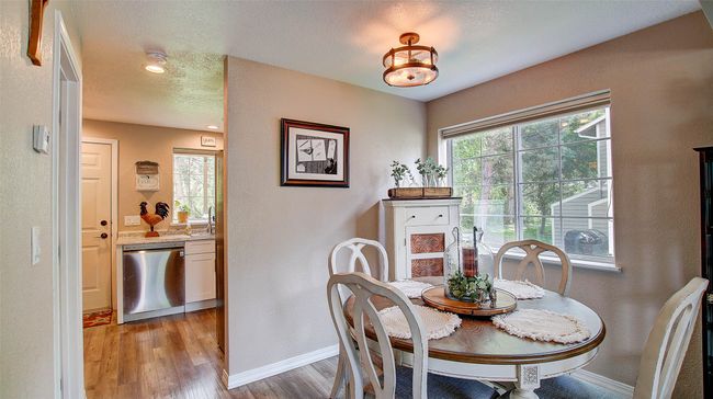 Dining room featuring light wood-style floors, recessed lighting, and a textured wall | Image 7
