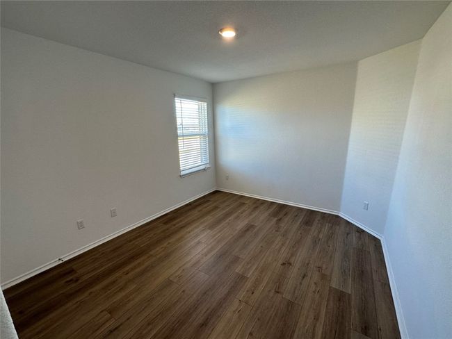 Empty room with recessed lighting, baseboards, and dark wood finished floors | Image 19