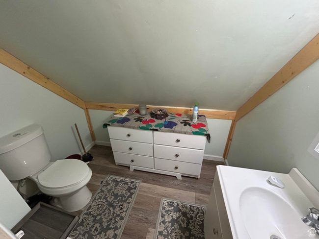 Bathroom with wood finished floors and vaulted ceiling | Image 23