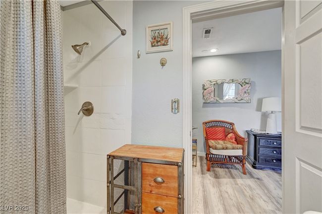 Full bathroom featuring a tile shower and wood finished floors | Image 48