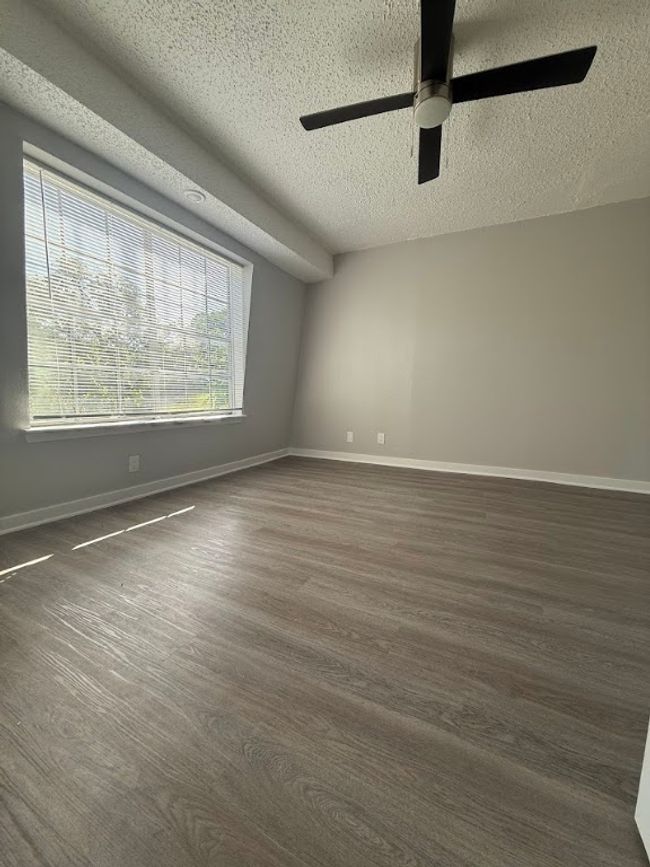 Spare room featuring a textured ceiling, ceiling fan, and baseboards | Image 14