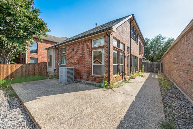 Back of property with a fenced backyard, a patio, brick siding, and roof with shingles | Image 20