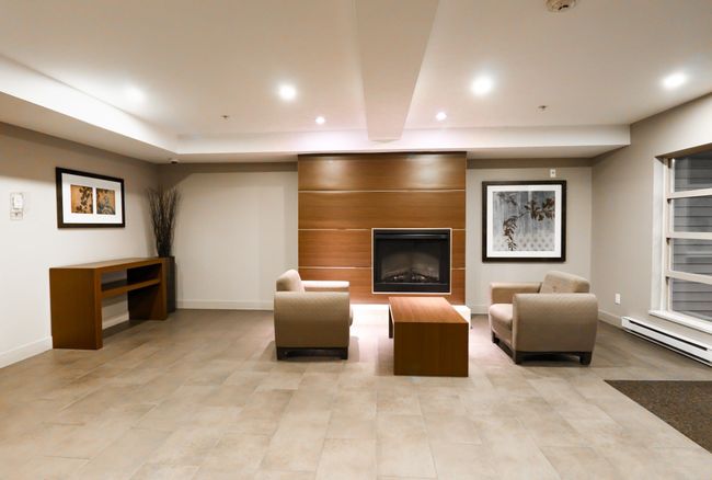 Living room featuring recessed lighting, a large fireplace, and a baseboard heating unit | Image 17