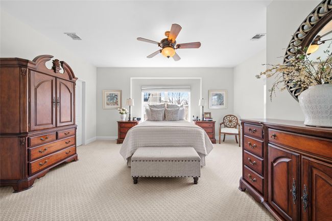 Bedroom with light carpet, baseboards, ceiling fan, and visible vents | Image 18