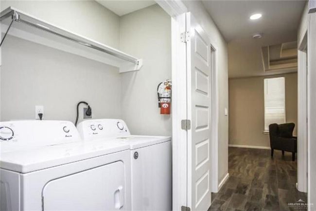 Laundry area featuring independent washer and dryer, dark wood-style floors, and recessed lighting | Image 6
