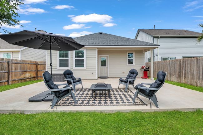 Back of property featuring a fire pit, a fenced backyard, a patio area, and roof with shingles | Image 26